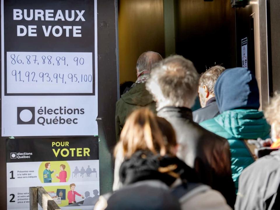 People line up to vote on Quebec election day in Montreal on Oct. 3.  (Graham Hughes/The Canadian Press - image credit)