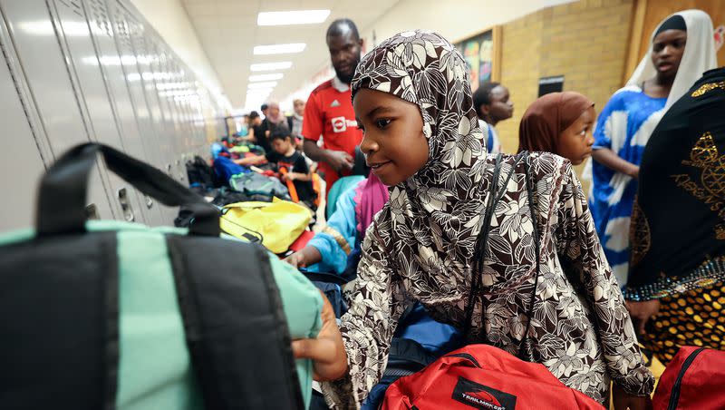 Fatima Musa picks out a backpack for fourth grade during Refugee Back to School Night at Granite Park Junior High in South Salt Lake on Monday, Aug. 7, 2023.