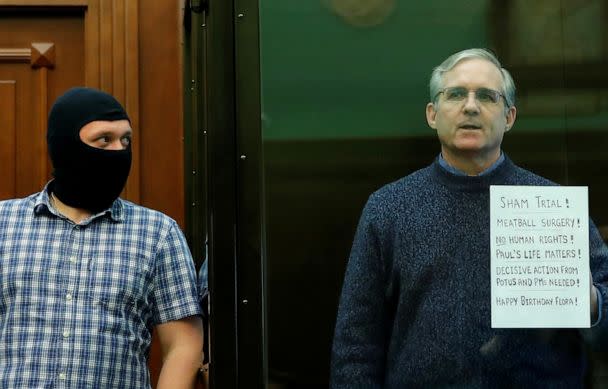 PHOTO: In this June 15, 2020, file photo, former U.S. Marine Paul Whelan, who was detained and accused of espionage, holds a sign as he stands inside a defendants' cage during his verdict hearing in Moscow. (Maxim Shemetov/Reuters, FILE)