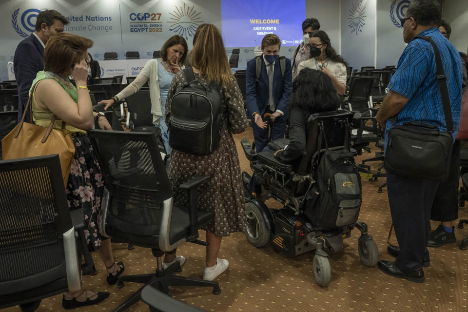 Jason Boberg, founding member of the disability climate action network SustainedAbility and climate disabilities activist, center, speaks with disabled persons after holding a panel discussion, during the COP27 U.N. Climate Summit, in Sharm el-Sheikh, Egypt, Wednesday, Nov. 9, 2022. (AP Photo/Nariman El-Mofty)