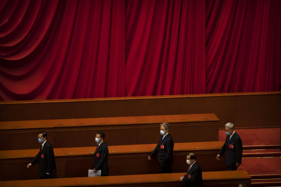 Delegates arrive for the closing session of China's National People's Congress (NPC) at the Great Hall of the People in Beijing, Thursday, May 28, 2020. China's ceremonial legislature has endorsed a national security law for Hong Kong that has strained relations with the United States and Britain. (AP Photo/Mark Schiefelbein)