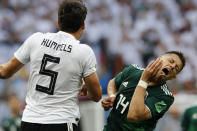 <p>Mexico’s Javier Hernandez and Mats Hummels clash in the second half (AP) </p>