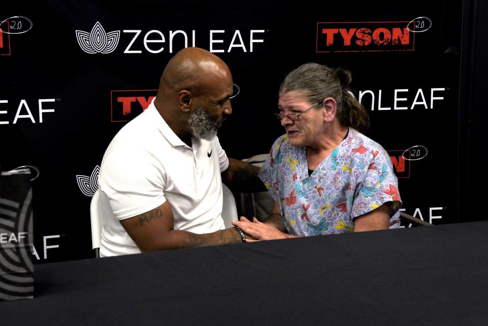 Jacqueline Schubert talks to Mike Tyson during a promotional tour of Tyson’s cannabis company Tyson 2.0 at Zen Leaf in Neptune Township, New Jersey on Saturday, September 3, 2022.