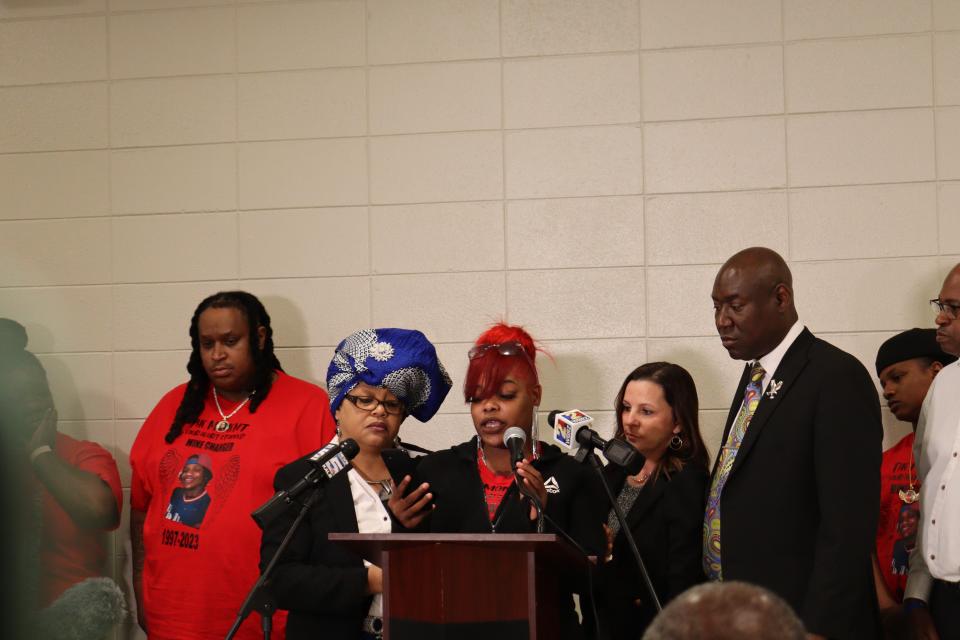 Liddie Balard (center), Jerome Stevenson's fiancée, reads a text message Friday during a press conference in Baton Rouge. To her left is Charlotte Guillot, who also provided text messages that attorney Ben Crump (left) says implicates an Avoyelles Parish warden in Stevenson's death.