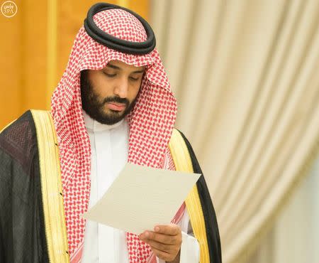 Saudi Arabia's Deputy Crown Prince Mohammed bin Salman looks at a document after Saudi Arabia's cabinet agrees to implement a broad reform plan known as Vision 2030 in Riyadh, April 25, 2016. REUTERS/Saudi Press Agency/Handout via Reuters