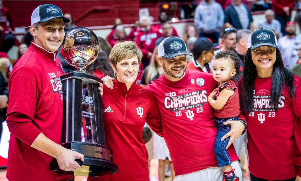 Indiana coaches, from left, Associate Head Coach Rhet Wierzba, Head Coach Teri Moren, Associate Head Coach Glenn Box, and Assistant Coach and Recruiting Coordinator Linda Sayavongchanh pose with the Big Ten Championship Trophy.