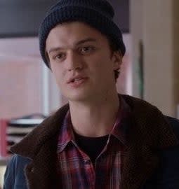 Joe Keery in a beanie and coat