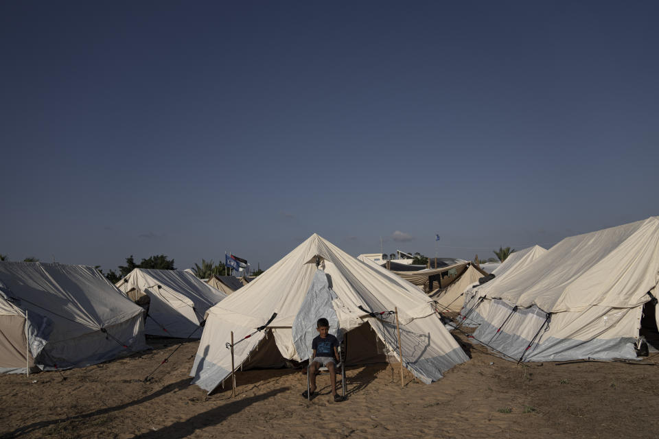 FILE - A Palestinian child displaced by the Israeli bombardment of the Gaza Strip sits in a UNDP-provided tent camp in Khan Younis on Thursday, Oct. 19, 2023. Hundreds of Palestinians have crowded into a squalid tent camp in southern Gaza, an image that has brought back memories of their greatest trauma. The impromptu construction of the tent city in Khan Younis to shelter scores of Palestinians who lost or fled their homes during the past days of intense Israeli bombardment has elicited anger, disbelief and sorrow across the Arab world. (AP Photo/Fatima Shbair, File)