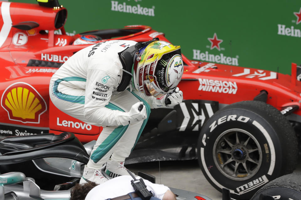 Mercedes driver Lewis Hamilton, of Britain, celebrates after winning the Brazilian Formula One Grand Prix at the Interlagos race track in Sao Paulo, Brazil, Sunday, Nov. 11, 2018. (AP Photo/Andre Penner)