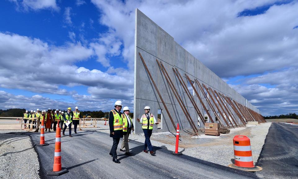 From left, Hitachi Rail CEO Andrew Barr, Maryland Gov. Larry Hogan and WMATA General Manager and CEO Randy Clarke tour the construction site for the new Hitachi Rail $70 million rail car factory and 800-yard test track Tuesday. The facility is being built on a 41-acre site near Halfway, Md.