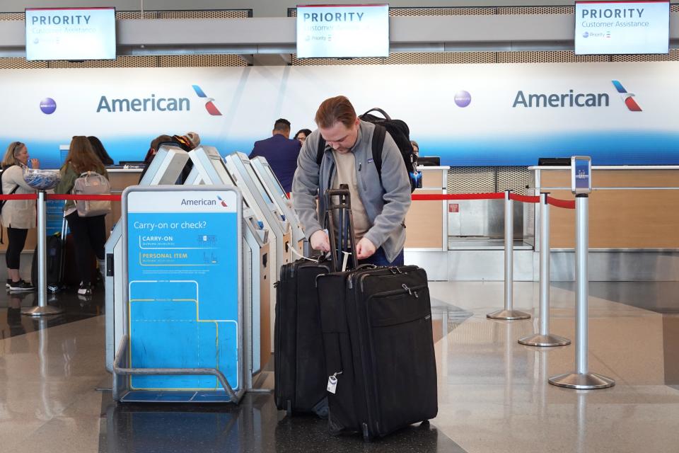 Passengers check in for an American Airlines flights at O'Hare International Airport on October 11, 2022 in Chicago, Illinois.