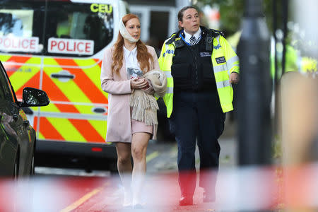 An injured woman is led away after an incident at Parsons Green underground station in London, Britain, September 15, 2017. REUTERS/Luke MacGregor