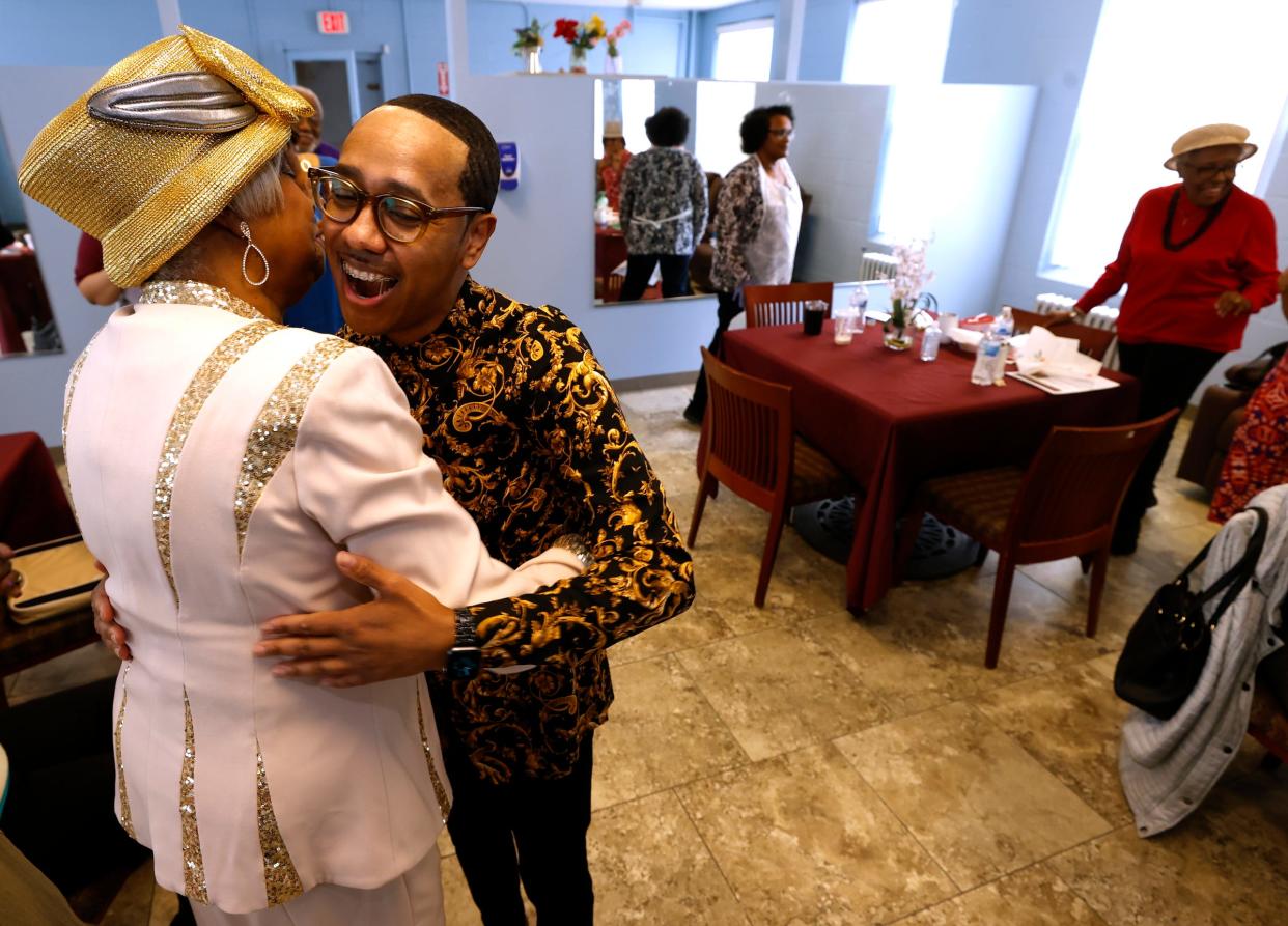 Carrie Thornton, 82, of Detroit, left, hugs Deon Mullen, 40, the senior director of senior outreach services at Franklin Wright Settlements in Detroit, after she and others sang "Happy Birthday" to him on Tuesday, April 4, 2023. Over 20 seniors were there for the twice-weekly "Food and Friendship," where they play games, do exercise routines and have lunch. Usually during Easter time, the seniors have food for an Easter celebration delivered to their homes but that couldn't happen this year, so Mullen made sure that the seniors had Easter dinner they could take home with them to make.