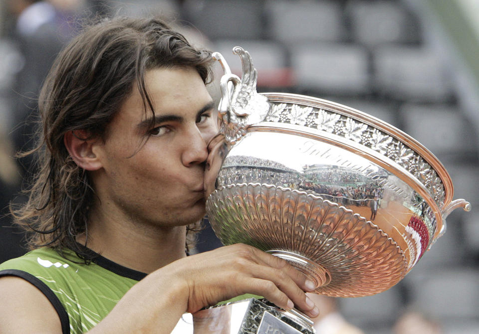 FILE - Spain's Rafael Nadal kisses the trophy after defeating Argentina's Mariano Puerta in their final match of the French Open tennis tournament at Roland Garros stadium, Sunday June 5, 2005, in Paris. (AP Photo/Michel Euler, FIle)