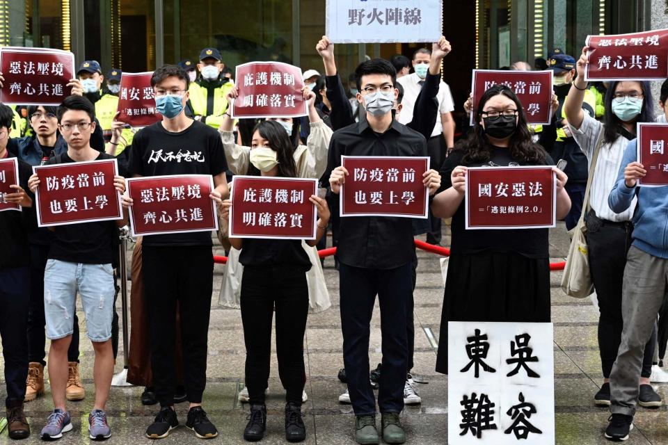 Students from Hong Kong and Taiwan display placards reading 'Bad laws of Chinas national security' during a protest (AFP via Getty Images)