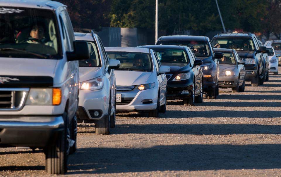 Hundreds of cars line up for the Emergency Food Bank's annual Thanksgiving food distribution held this year at the San Joaquin County Fairgrounds in Stockton Nov. 24, 2020.