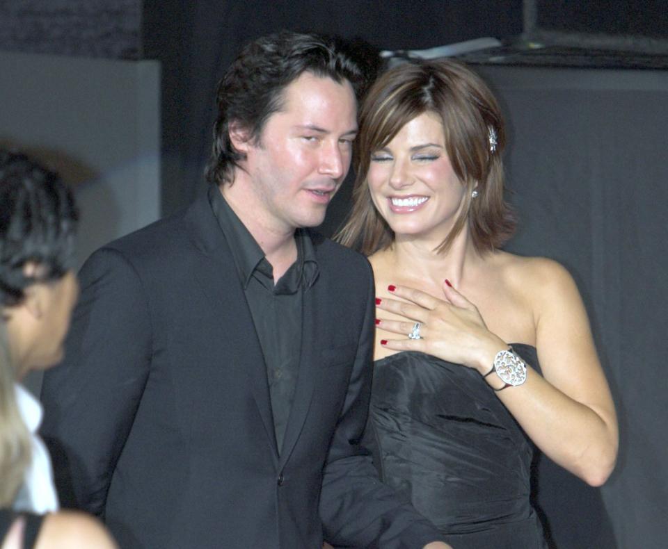 Sandra smiles while walking with Keanu