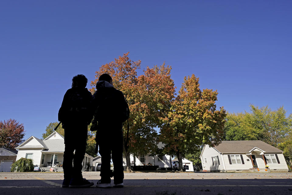 Students wait for their rides after classes at Highland Elementary School in Columbus, Kan., on Monday, Oct. 17, 2022. Third graders in the tiny 900-student Columbus school district have fought to catch up on reading in the wake of COVID-19 disruptions. (AP Photo/Charlie Riedel)