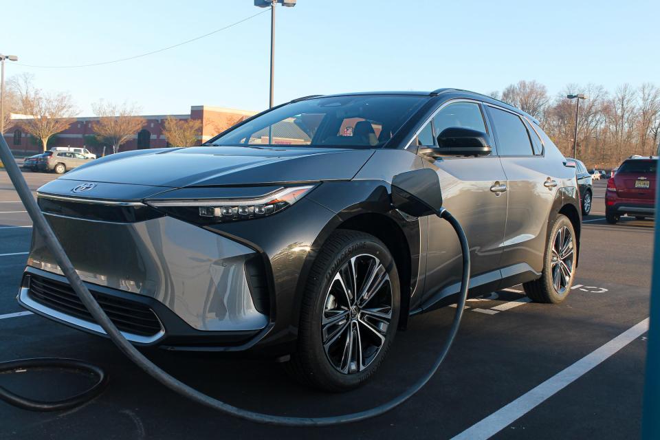 The 2023 Toyota bZ4X AWD Limited, viewed from the front against a blue sky.