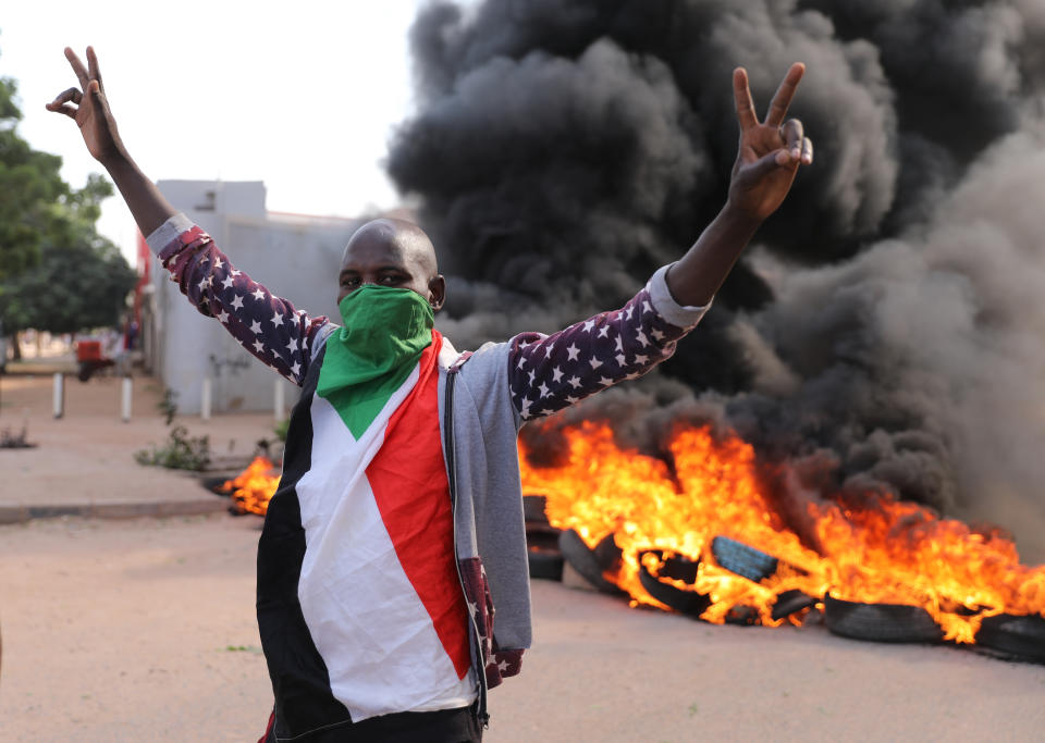 A demonstrator gives the victory sign at a protest, in Khartoum, Sudan, Wednesday, Oct. 21, 2020. Protesters have taken to the streets in the capital and across the country over dire living conditions and a deadly crackdown on demonstrators in the east earlier this month. Sudan is currently ruled by a joint civilian-military government, following the popular uprising that toppled longtime autocrat Omar al-Bashir last year. (AP Photo/Marwan Ali)