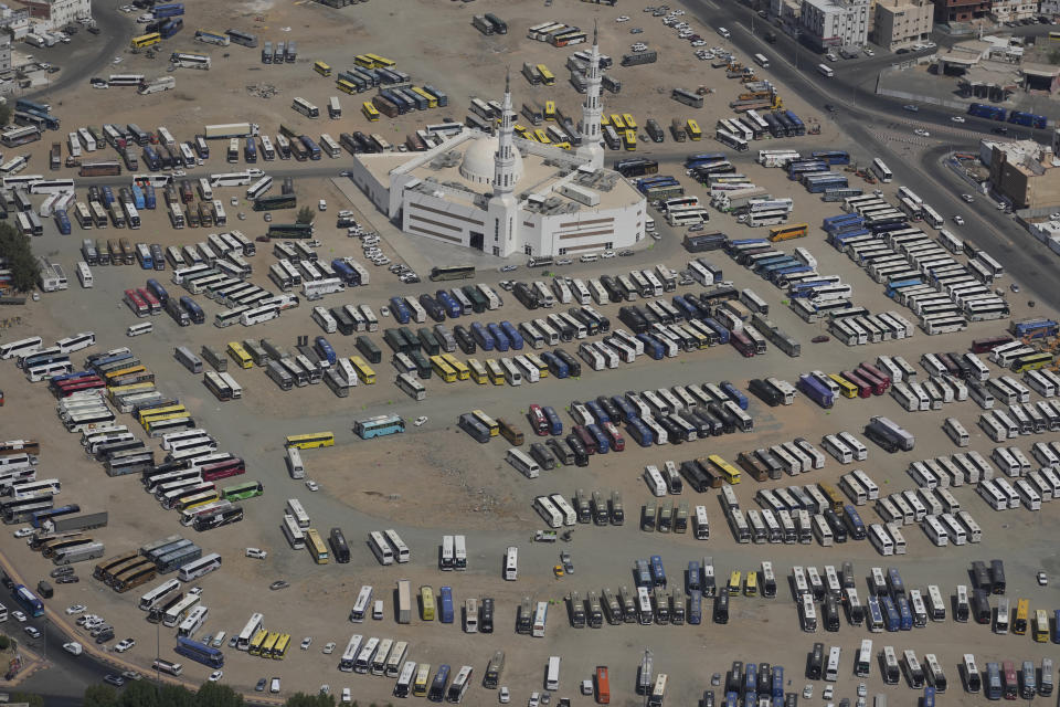 Pilgrim buses line up during the annual hajj pilgrimage in Mina, near the holy city of Mecca, Saudi Arabia, Monday, June 17, 2024. Muslim pilgrims used the early morning hours Monday to perform the second day of the symbolic stoning of the devil, as noontime summer heat caused heatstroke among thousands wrapping up the Hajj pilgrimage. (AP Photo/Rafiq Maqbool)