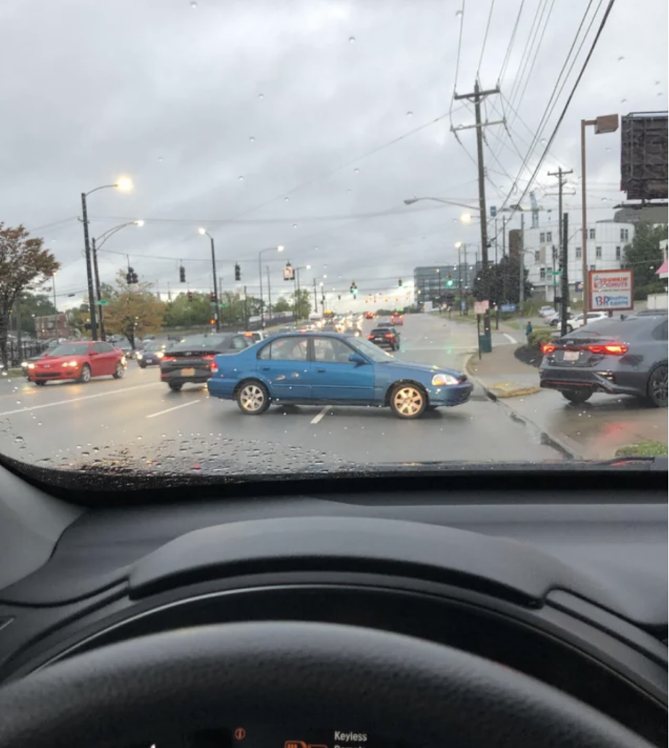 A car blocking traffic to pull into a drive-thru