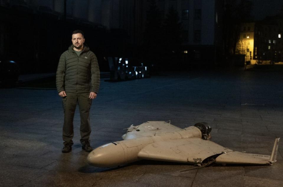 Ukrainian President Volodymyr Zelenskyy stands next to an Iranian-made Shahed-136 drone.