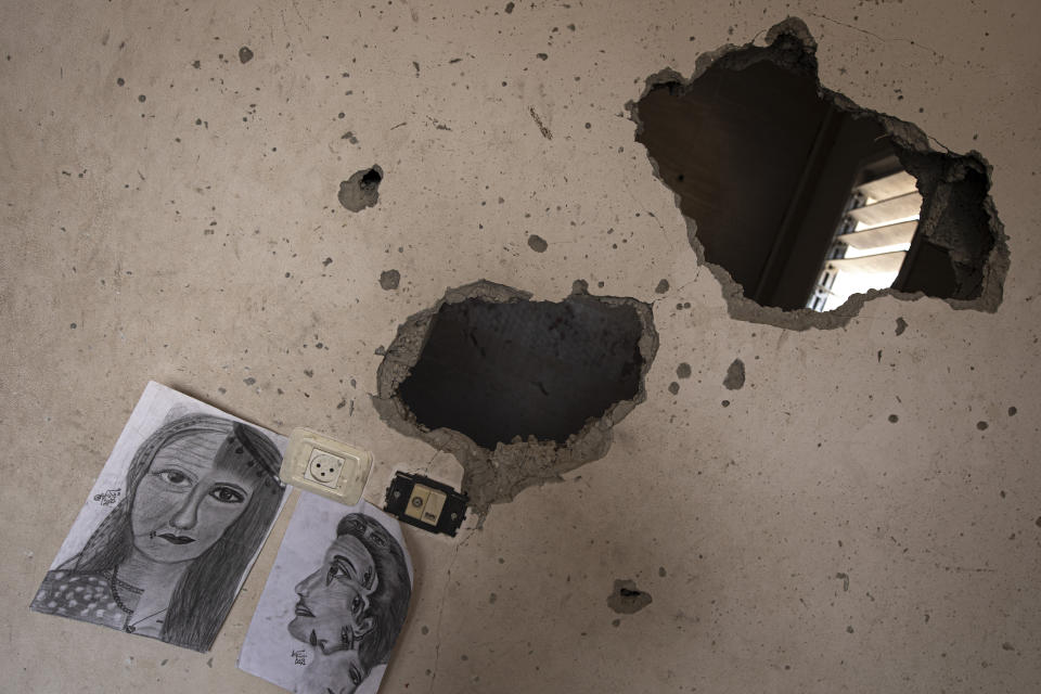 Drawings by Duniana al-Amour are seen in her damaged bedroom which was hit by Israeli strike, east of Khan Yunis, in the southern Gaza Strip, Monday, Aug. 10, 2022. Al-Amour, a 22-year-old Palestinian woman who had retreated into her artistic pursuits during Gaza's past wars was among the first people killed by Israeli strikes in the latest round of violence. Shrapnel tore through her bedroom during Israel’s surprise opening salvo last Friday, hours before militants fired any rockets. (AP Photo/Fatima Shbair)