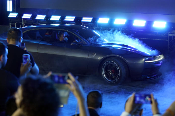 The Dodge Charger Daytona SRT concept is unveiled, Wednesday, Aug. 17, 2022, in Pontiac, Mich. Thundering gas-powered muscle cars will be closing in on their final Saturday night cruises in the coming years as automakers begin replacing them with super-fast cars that run on batteries. (AP Photo/Carlos Osorio)