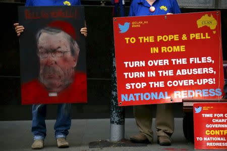 Victims and relatives of children who claim they were sexually abused by the Catholic Church hold placards as they stand outside the venue for Australia's Royal Commission into Institutional Response to Child Sexual Abuse in Sydney, Australia, February 29, 2016. REUTERS/David Gray