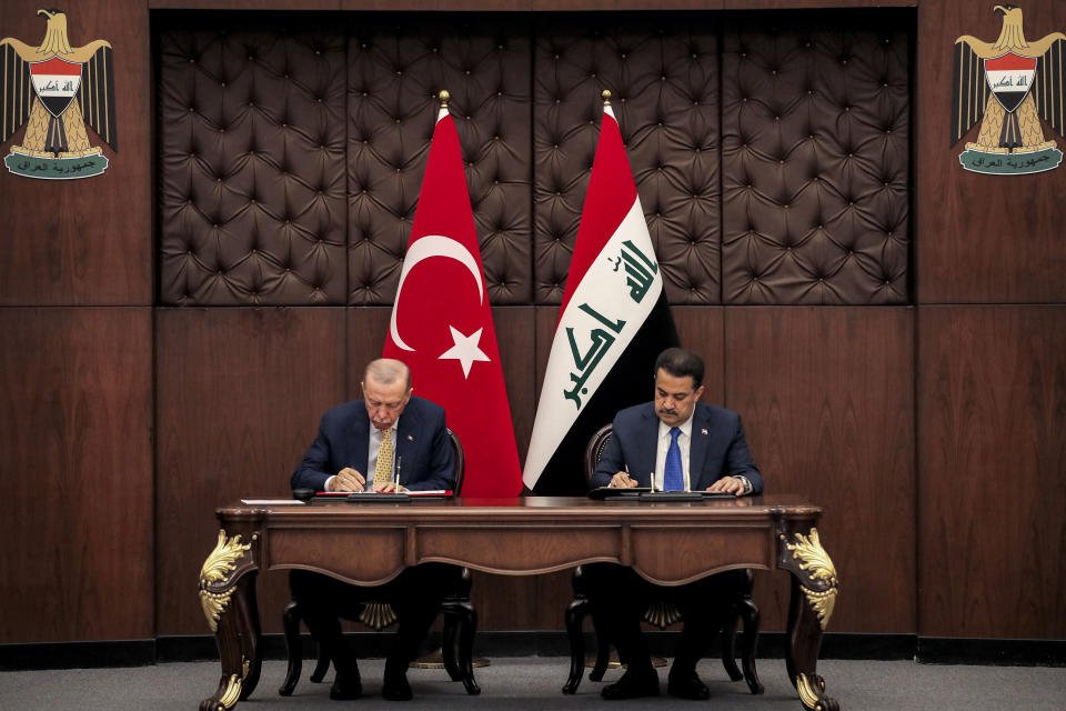 Iraq's Prime Minister Mohammed Shia al-Sudani, right, and Turkey's President Recep Tayyip Erdogan sign mutual agreements during their meeting in Baghdad, April 22, 2024. (AHMAD AL-RUBAYE / Pool Photo via AP)