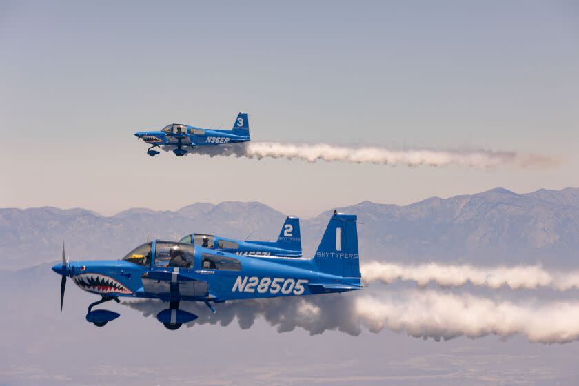 Los Angeles, CA - July 04: The Skytypers planes release smoke to write "Happy Fourth" on Monday, July 4, 2022 in Los Angeles, CA. Pilots manually maintain their tight abreast formation, and an automated program patented by Owner Stephen Stinis' grandfather, Andy Stinis, releases smoke from each plane independently to create matrix-messages of smoke dots. (Wesley Lapointe / Los Angeles Times)