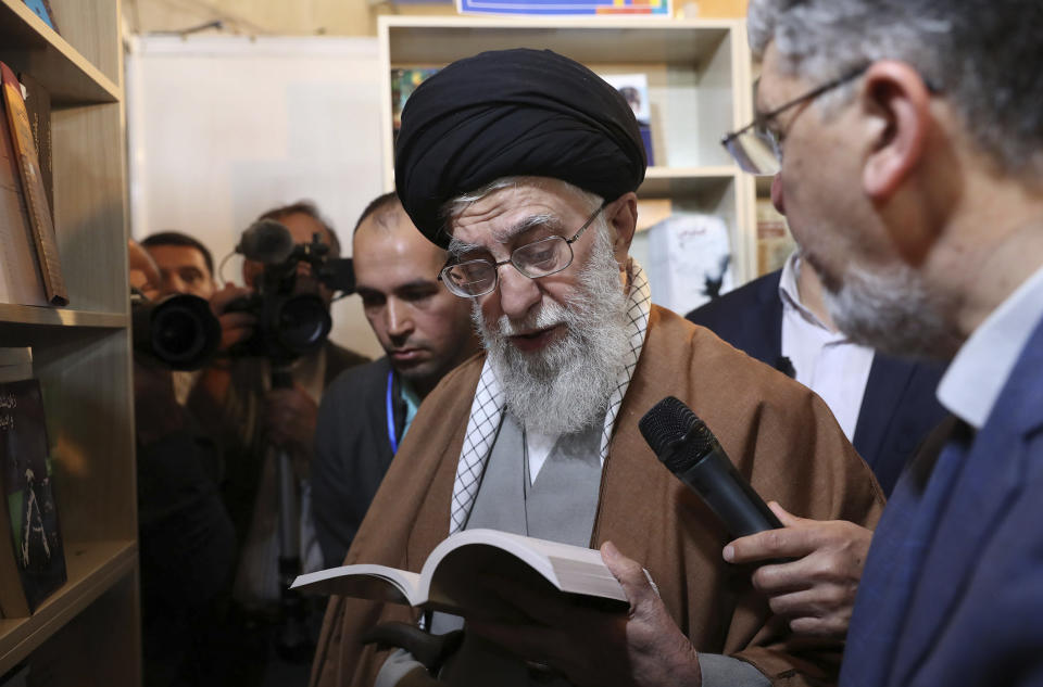 In this picture released on April 29, 2019, by the official website of the office of the Iranian supreme leader, Supreme Leader Ayatollah Ali Khamenei reads part of a book while visiting Tehran's book fair in Tehran, Iran. President Donald Trump signed an executive order on Monday, June 24, 2019, targeting Iran's supreme leader and his associates with financial sanctions, the latest action the U.S. has taken to discourage Tehran from developing nuclear weapons and supporting militant groups. (Office of the Iranian Supreme Leader via AP)