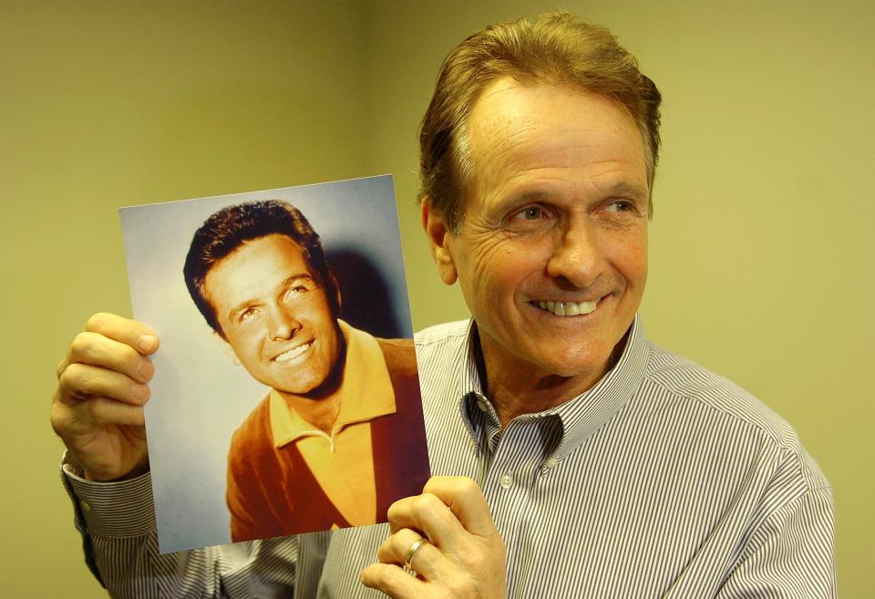 Mark Goddard, who played Major Don West in the hit television series "Lost In Space", holds a photograph of himself from the show. Goddard was the grand marshal at the Holiday Parade in Brockton in 2008.