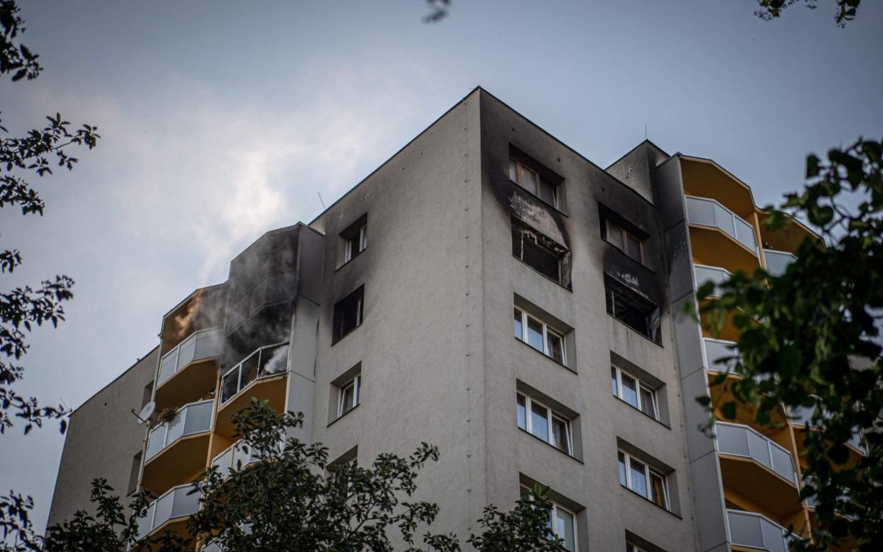 Smoke can still be seen billowing from balconies after a fire broke out in an apartment block in Bohumin - AFP