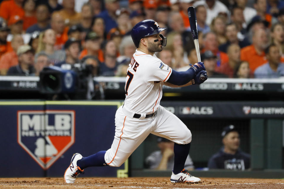 Houston Astros' Jose Altuve hits a double against the New York Yankees during the first inning in Game 6 of baseball's American League Championship Series Saturday, Oct. 19, 2019, in Houston.(AP Photo/Matt Slocum)