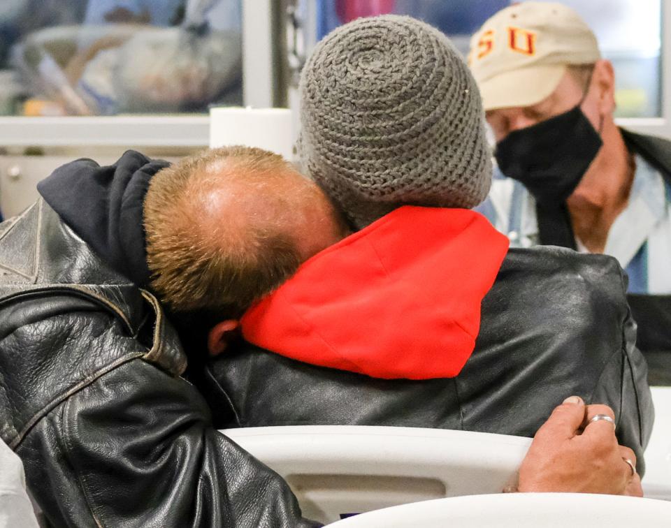 A couple relax after getting a hot meal as One Hopeful Place resumed its role as the cold night shelter in south Okaloosa County.