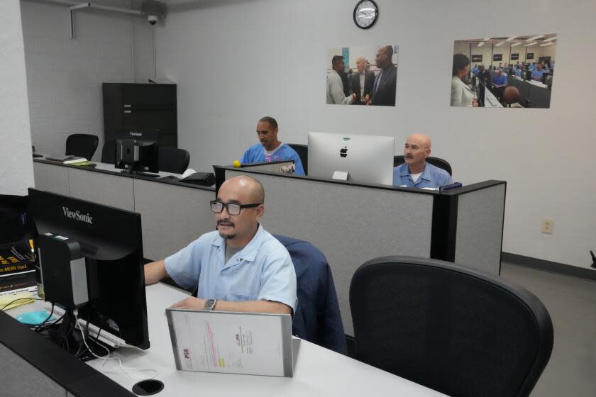 Incarcerated men including Khiem Tran, foreground, work in the coding center at San Quentin State Prison in San Quentin, Calif., Friday, March 17, 2023. Gov. Gavin Newsom plans to transform San Quentin State Prison, a facility in the San Francisco Bay Area known for maintaining the highest number of prisoners on death row in the country. Newsom said Friday his goal is to turn the prison into a place where inmates can be rehabilitated and receive job training before returning to society. (AP Photo/Eric Risberg)