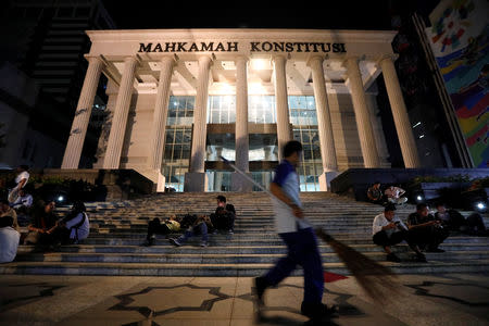 A cleaning worker walks outside Indonesia's constitutional court in Jakarta, Indonesia, May 24, 2019. REUTERS/Willy Kurniawan