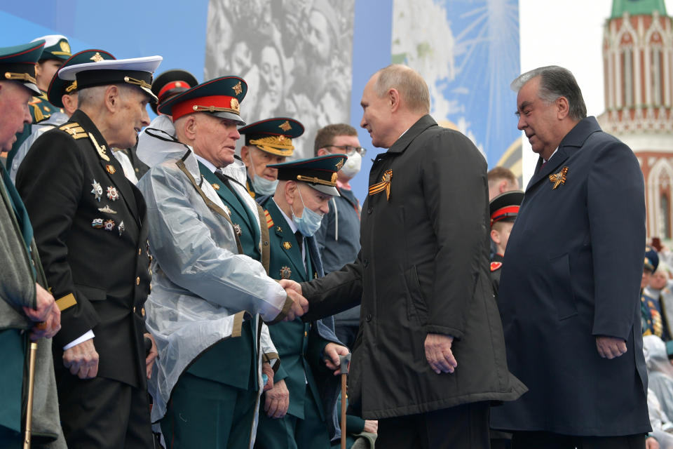 Russian President Vladimir Putin, second from right, and Tajikistan's President Emomali Rakhmon, right, shake hands with WWII veterans before the Victory Day military parade in Moscow, Russia, Sunday, May 9, 2021, marking the 76th anniversary of the end of World War II in Europe. (Alexei Druzhinin, Sputnik, Kremlin Pool Photo via AP)