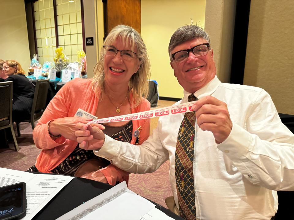 Cathy Brown and Tim Cornell show off their raffle tickets at the Soroptimist International of Palm Desert (SIPD)'s Live Your Dream Awards on March 8, 2024.