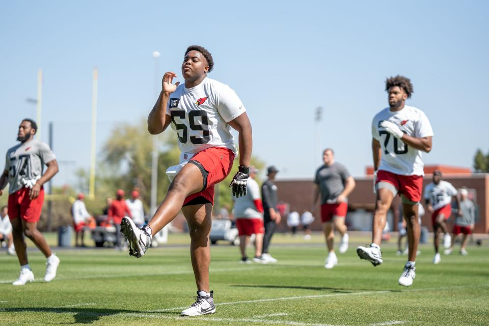 Arizona Cardinals offensive linemen Jon Gaines II (59) and Paris Johnson Jr. (70) practice in the Cardinals rookie minicamp in Tempe on May 12, 2023.