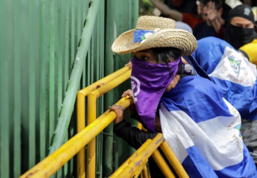 Protesters demonstrate in front of a police line at the Central American University in Managua on November 19