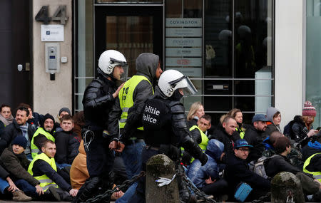 A demonstrator is detained by police during the "yellow vests" protest against higher fuel prices, in Brussels, Belgium, December 8, 2018. REUTERS/Yves Herman