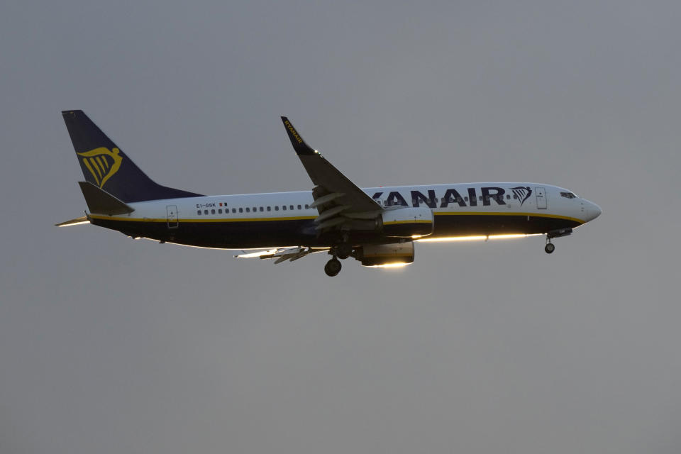 A Ryanair Boeing 737 approaches for landing in Lisbon at sunset, Tuesday, June 13, 2023. (AP Photo/Armando Franca)