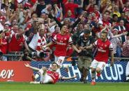 Arsenal's Aaron Ramsey (L) celebrates with team mates Kieran Gibbs (C) and Jack Wilshere after scoring his team's third goal during their FA Cup final match against Hull City at Wembley Stadium in London, May 17, 2014. REUTERS/Eddie Keogh