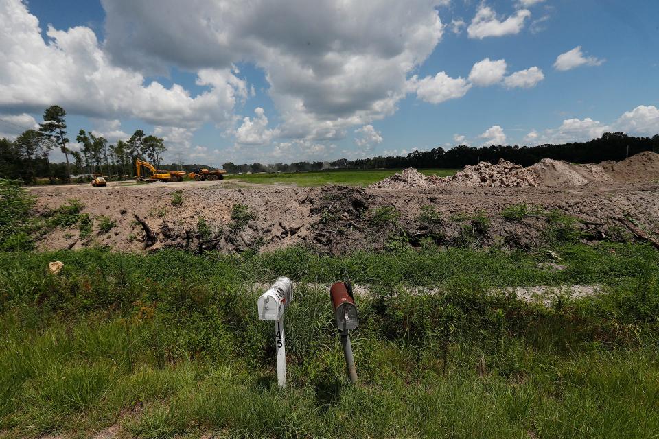 A pair of aged mailboxes sit along Monteith Road in front of a future logistics park on Hendley Road.