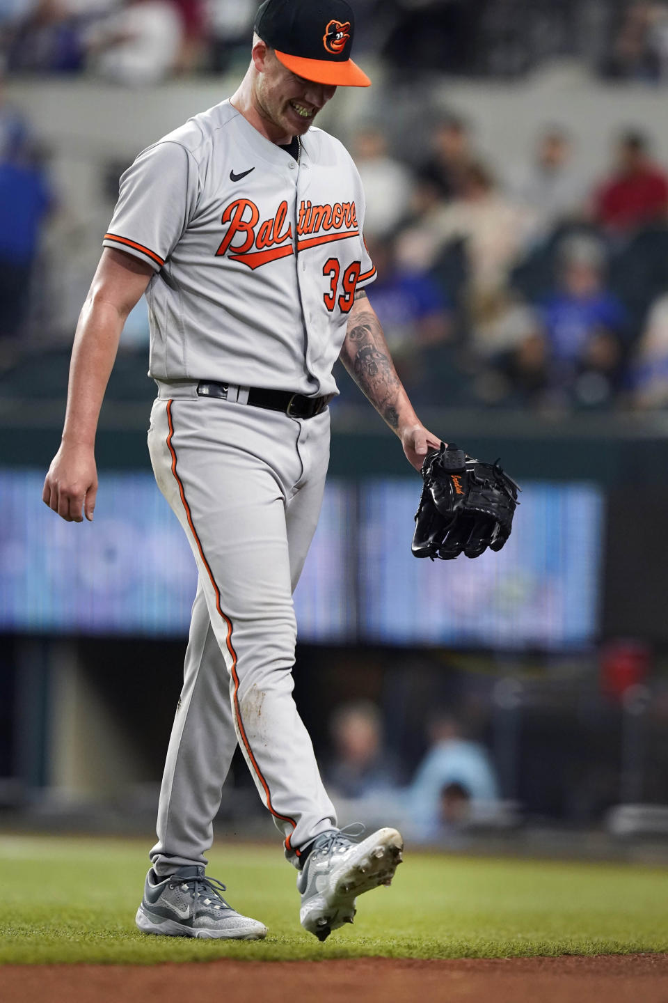 Baltimore Orioles starting pitcher Kyle Bradish walks off the field after injuring his foot during the second inning of a baseball game against the Texas Rangers in Arlington, Texas, Monday, April 3, 2023. (AP Photo/LM Otero)