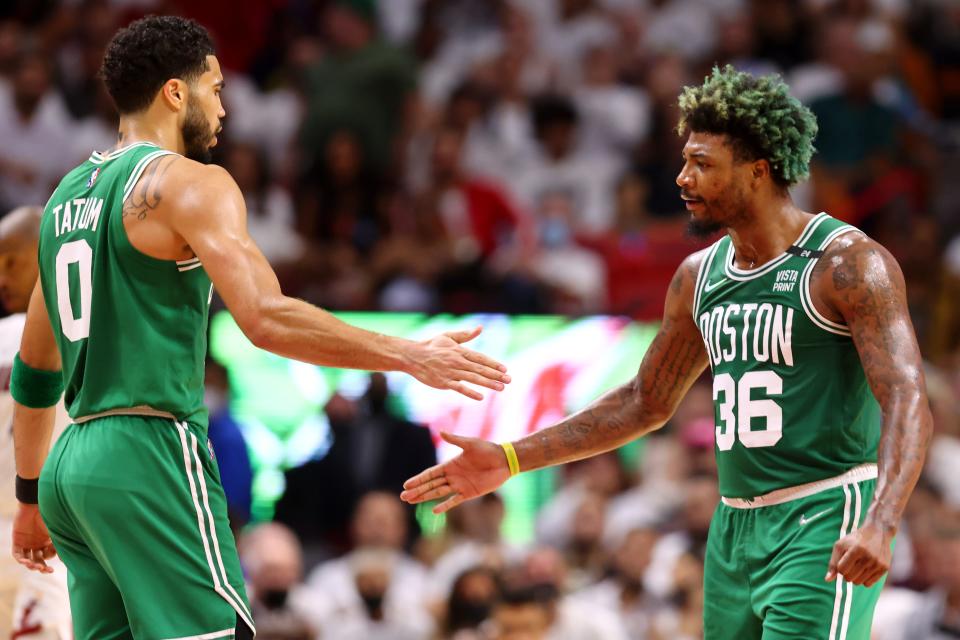 Jayson Tatum and Marcus Smart celebrate after a first-half bucket.