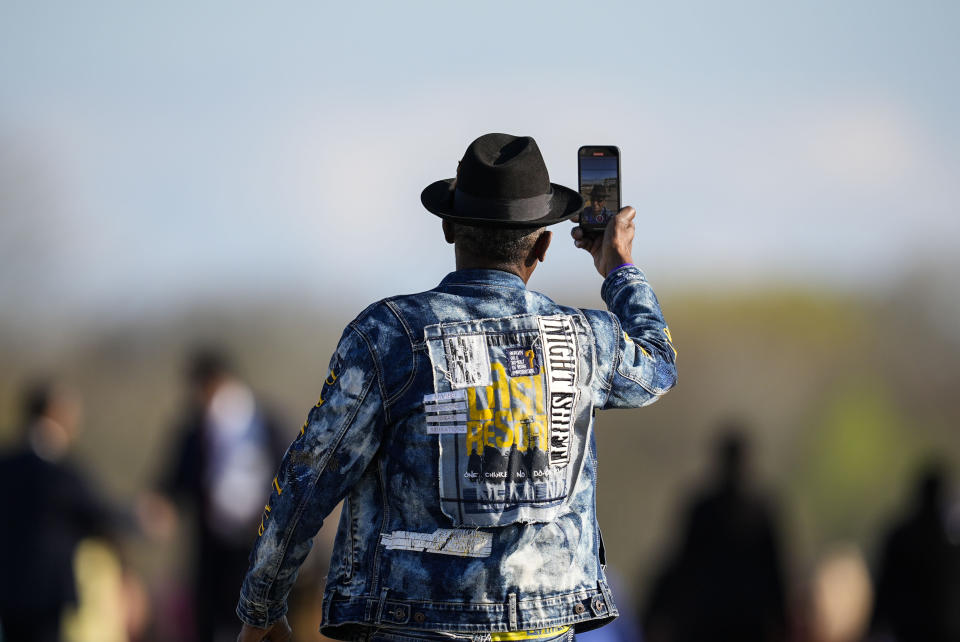 A man walks across the Edmund Pettus Bridge with hundreds of others commemorating the 59th anniversary of the Bloody Sunday voting rights march in 1965, Sunday, March 3, 2024, in Selma, Ala. (AP Photo/Mike Stewart)